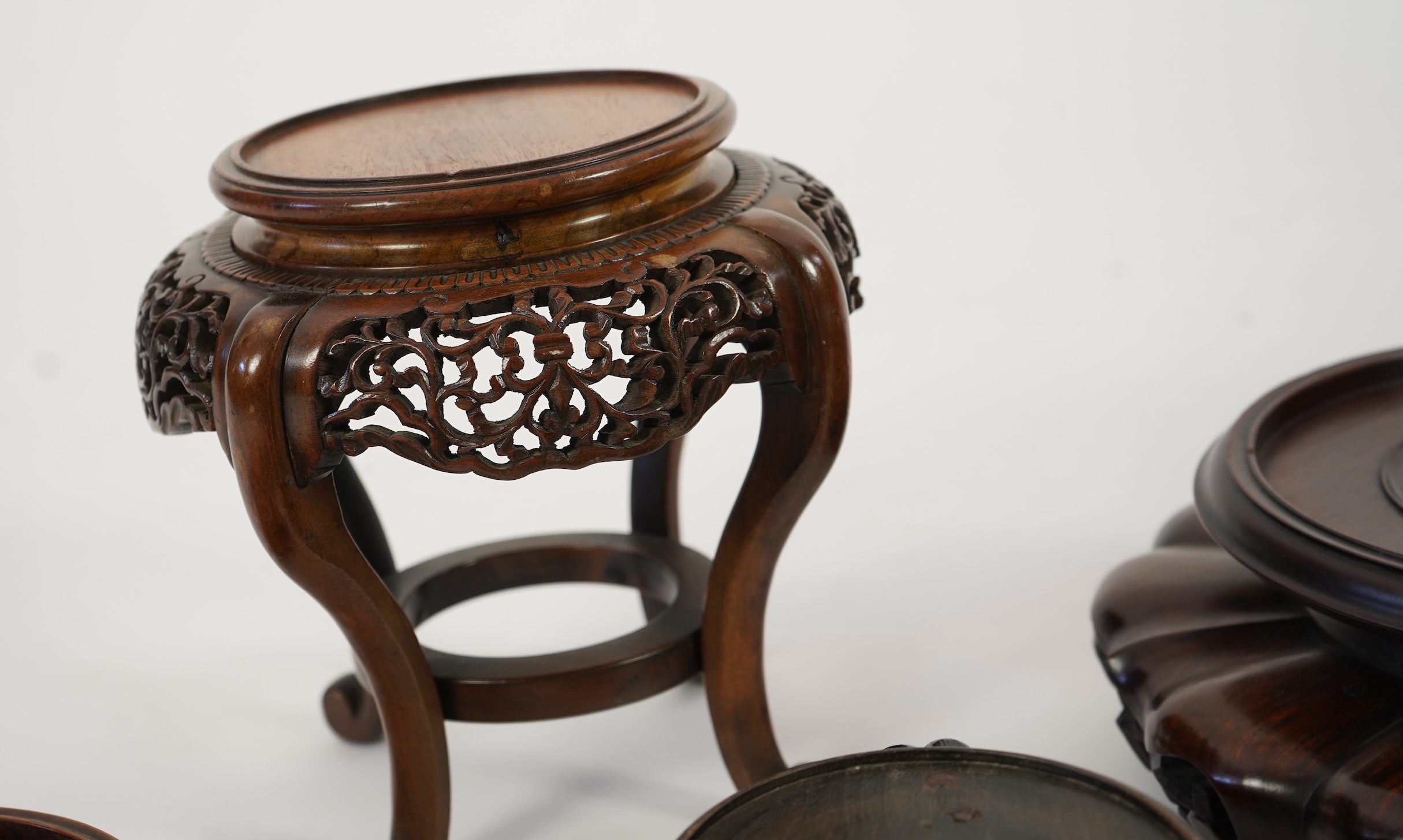 A group of sixteen Chinese hardwood stands together with a Japanese stand, 19th/20th century